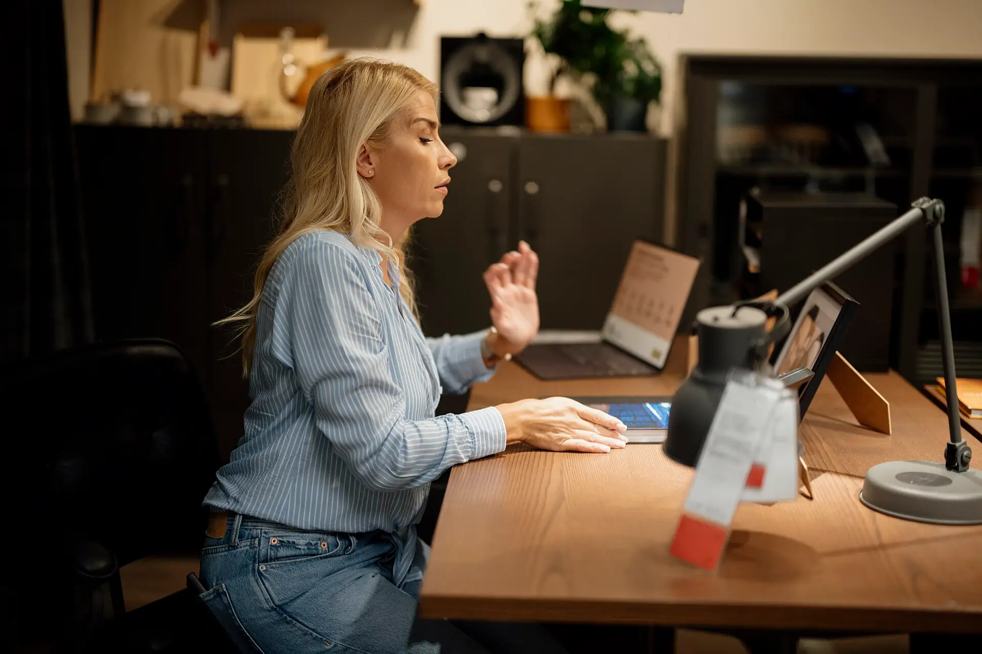 A woman working at a desk in a home office