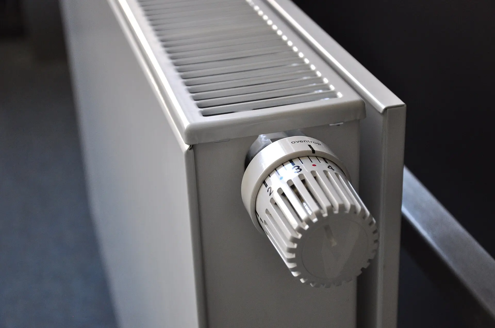 Close-up of a panel radiator with a thermostatic valve